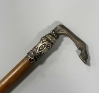 A rhino horn and silver coloured metal mounted riding crop, late 19th century,