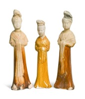 A group of four Chinese partly straw-glazed pottery lady court attendants, Tang Dynasty,