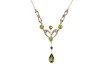 A gem-set lavalier necklace, set with seed pearls and garnet-topped doublets, in a yellow metal mount to a trace link chain with a hook clasp, surface tested as 9ct gold; 3.8 grams. Please note: Unless otherwise stated, lots have been tested using an elec