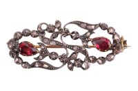 An Early to Mid-19th century gem-set brooch, of floral design; the openwork surround with stylised foliate and flowerheads, set with rose-cut diamond points, highlighted with two pear-cut pink paste in cut-down mounts, brooch fittings to the reverse with 