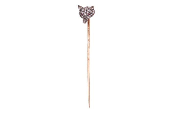A Victorian gem-set fox stick pin, composed of a fox&rsquo;s head set with rose-cut diamonds, with ruby cabochon eyes, in bicolour metal, leading to a yellow metal pin surface tested as 18ct, in a fitted box; 1.3 grams Please note: Unless otherwise stated, lots