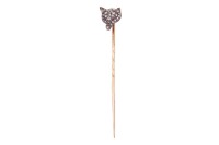 A Victorian gem-set fox stick pin, composed of a fox&rsquo;s head set with rose-cut diamonds, with ruby cabochon eyes, in bicolour metal, leading to a yellow metal pin surface tested as 18ct, in a fitted box; 1.3 grams Please note: Unless otherwise stated, lots
