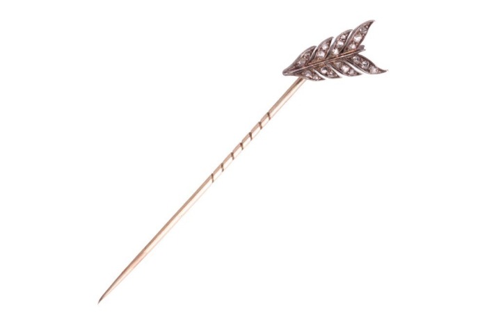 A Victorian diamond-set arrow stick pin, the angled fletching encrusted with graduated rose-cut diamonds, set to a tapering pin, unmarked metal testing as silver on 9ct, 7.5 cm long, 2.6 grams. Please note: Unless otherwise stated, lots have been tested u