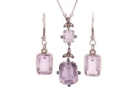 An Edwardian amethyst and diamond lavaliere necklace and a pair of earrings; the pendant of floral design, comprising a pale octagonal-cut amethyst of 15.2 x 12.4 x 8.5 mm, in claw setting with diamond accents to the cardinal points, to a conforming surmo