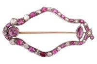 A ruby and diamond-set openwork navette brooch, composed of a row of alternating ruby and rose-cut diamonds (with four later-added synthetic rubies), of navette form, in cut-down white metal mounts, with two additional rubies set to the inside of the ruby