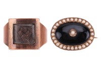 An early 19th century mourning ring, with plaited hair behind the central glass compartment, engraved to the interior: &lsquo;John Hinsum, 26 May, 1802, At 60&rsquo;, in a rose metal mount, surface tested as 9ct, size Q, together with a Victorian onyx and seed pearl 