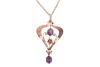 An Edwardian amethyst-set pendant, claw-set with two oval-cut amethysts, in a yellow metal mount of scrolling and floral design, marked &lsquo;9ct&rsquo;, to a base metal chain; total weighable: 1.4 grams