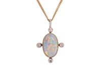 An opal-set pendant, composed of an oval-shaped precious opal cabochon, displaying strong spectral play of colour to a white background, measuring approximately 14mm x 9mm, in a bezel setting with millegrain detailing, accented by bezel-set old-cut diamon