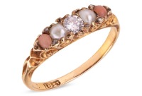 A diamond, pearl and coral half-hoop ring, centred with a round brilliant-cut diamond, flanked by two split pearls and two corallium rubrum cabochons, in a scrolled mount leading to a D-profile shank, in yellow metal stamped '18ct', size L, 2.2 grams. Dia