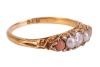 A diamond, pearl and coral half-hoop ring, centred with a round brilliant-cut diamond, flanked by two split pearls and two corallium rubrum cabochons, in a scrolled mount leading to a D-profile shank, in yellow metal stamped '18ct', size L, 2.2 grams. Dia - 4