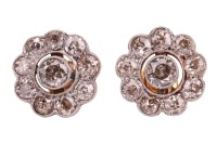A pair of diamond-set floral earrings, with a central old-cut diamond, each with an estimated carat weight of 0.42ct, surrounded by nine smaller old-cut diamonds, with millegrain detailing, in bi-colour metal mounts, with later added post fittings hallmar