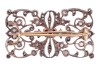 A late Victorian diamond and ruby brooch, of scrolled foliate design, the openwork mount encrusted with old-cut diamonds and rose-cut diamond points, centred with a cushion-cut ruby in collet with twisted cable edge, measures 6.7 x 4.7 mm, unmarked metal - 3
