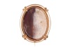 A hardstone cameo reliquary, the ferruginous quartz (or rhyolite?) relief-carved with the portrait of Jesus, set in an oval frame, intercardinal points adorned with brilliant-cut diamond accents, base deficient, unmarked yellow metal surface testing as 18 - 2