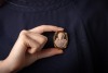A hardstone cameo reliquary, the ferruginous quartz (or rhyolite?) relief-carved with the portrait of Jesus, set in an oval frame, intercardinal points adorned with brilliant-cut diamond accents, base deficient, unmarked yellow metal surface testing as 18 - 3