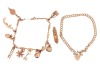 Two bracelets and a loose charm; comprising a charm bracelet with nine charms on engraved navette links, in yellow metal stamped '585', 19.5 cm; a 9ct gold double curb link chain with heart-shaped padlock clasp, 18.0 cm long; and a loose Mezuzah charm sta