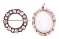 Two brooches; comprising an aquamarine and split pearl wreath-style brooch, with millegrain detailing, in a white metal mount marked &lsquo;9ct&rsquo;, with brooch pin fitting to the reverse, together with a white enamel oval locket, with glass compartment, the glass
