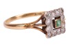 An emerald and diamond dress ring; centred with a square-cut emerald of 2.5 mm, within a scalloped frame surround set with single-cut diamonds, between trifurcated shoulders to D-profile shank marked '18ct', ring head measures 1.0 cm wide, size V, 3.8 gra - 3