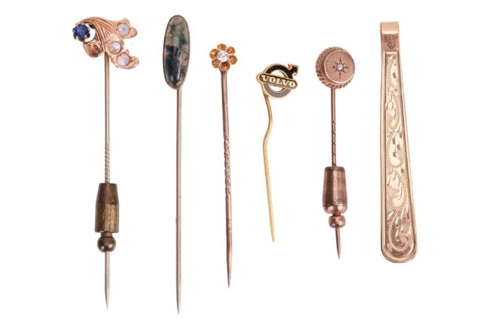 A group of gem-set stick pins; to include an example of an old-cut diamond in buttercup mount, one set with moss agate, another one with rose-cut diamond point, together with a 9ct yellow gold tie clip; total weighable 11.6 grams.