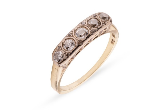 A five-stone diamond ring, comprising five graduating old-cut diamonds, the stones collet-set, the setting further highlighted with rose-cut diamonds, to a yellow metal ring shank of D-profile, marked &lsquo;585&rsquo;, size P &frac12;, 4.0 grams. Centre Diamond measuring a