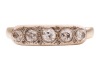 A five-stone diamond ring, comprising five graduating old-cut diamonds, the stones collet-set, the setting further highlighted with rose-cut diamonds, to a yellow metal ring shank of D-profile, marked &lsquo;585&rsquo;, size P &frac12;, 4.0 grams. Centre Diamond measuring a - 2