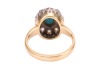 A turquoise and diamond cluster ring, centred with an oval turquoise cabochon in collet, encircled by ten old-cut diamonds, between grooved shoulders to D-profile shank, unmarked metal testing as 18ct, ring head 1.4 x 1.1 cm, size J, 4.2 grams. Please not - 4