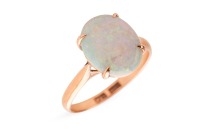 An opal dress ring, claw-set with a precious opal cabochon of 11.0 x 8.7 mm in a closed-back mount, between tapered shoulders, in yellow metal stamped '14K', size L, 2.3 grams.