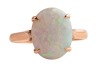 An opal dress ring, claw-set with a precious opal cabochon of 11.0 x 8.7 mm in a closed-back mount, between tapered shoulders, in yellow metal stamped '14K', size L, 2.3 grams. - 2
