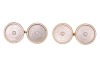A pair of mother-of-pearl cufflinks, of circular form, each set with an engraved mother-of-pearl panel, centred with a split pearl accent, within a white enamelled frame, in yellow metal surface testing as 14ct, panel measures 1.3 cm across, 4.1 grams. Pl