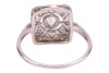 An Art Deco style panel ring, centrally-set with a bezel-set round brilliant diamond, within a diamond-set openwork panel, to a white metal shank marked &lsquo;plat&rsquo;, size N; 3.3 grams. - 3