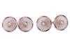 Krementz - a pair of rock crystal and split pearl cufflinks; the round and frosted rock crystal panels with carved radiating patterns, in a millgrained frame with foliate and black enamel details, centred with an applied split pearl, bar link connections 