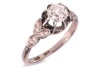 A late Art Deco diamond solitaire ring, centred with an Old-European cut diamond of 5.6 mm, estimated weight 0.70ct, in a buttercup mount between foliate shoulders, white metal stamped '18ct PLAT', size M&frac12;, 3.4 grams. Diamond approximately measures 5.6 x 
