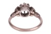 A late Art Deco diamond solitaire ring, centred with an Old-European cut diamond of 5.6 mm, estimated weight 0.70ct, in a buttercup mount between foliate shoulders, white metal stamped '18ct PLAT', size M&frac12;, 3.4 grams. Diamond approximately measures 5.6 x - 3