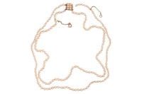 A double-row natural saltwater pearl necklace, comprising two strands of off-round pearls, with an average 3.5 mm in diameter, hand-knotted to a box clasp encrusted with split pearls, unmarked pink coloured metal surface testing as 14ct, overall length 38