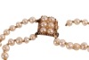 A double-row natural saltwater pearl necklace, comprising two strands of off-round pearls, with an average 3.5 mm in diameter, hand-knotted to a box clasp encrusted with split pearls, unmarked pink coloured metal surface testing as 14ct, overall length 38 - 2