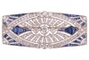 An Art Deco sapphire and diamond-set brooch, of architectural design; the rounded rectangular openwork frame centrally-set with three old-cut diamonds, with millegrain bezel surround, the largest diamond measuring approximately 4.5mm, within a navette-sha