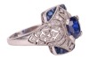 A sapphire and diamond panel ring, centred with an oval-cut sapphire of 6.8 x 6.2 x 3.8mm, in a millgrained pierced mount encrusted with single-cut diamonds with calibre-cut sapphire corners, white metal surface testing as platinum, ring head 1.5 x 1.2 cm - 4