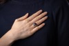 A sapphire and diamond panel ring, centred with an oval-cut sapphire of 6.8 x 6.2 x 3.8mm, in a millgrained pierced mount encrusted with single-cut diamonds with calibre-cut sapphire corners, white metal surface testing as platinum, ring head 1.5 x 1.2 cm - 5