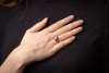 A diamond-set solitaire ring, composed of an illusion-set round brilliant cut diamond, measuring approximately 4.5mm, with an estimated carat weight of 0.36ct, the high gallery leading to foliate-style shoulders, to a white metal shank marked &lsquo;18ct&rsquo;, size - 2