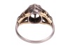 A diamond-set solitaire ring, composed of an illusion-set round brilliant cut diamond, measuring approximately 4.5mm, with an estimated carat weight of 0.36ct, the high gallery leading to foliate-style shoulders, to a white metal shank marked &lsquo;18ct&rsquo;, size - 5