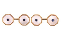 Asprey - a pair of sapphire and mother-of-pearl cufflinks, the octagonal-shaped cufflinks centred with a bezel-set sapphire, to a mother-of-pearl plaque with reeded border, with chain connectors, hallmarked 18ct gold, Birmingham, 1989, with maker&rsquo;s marks 