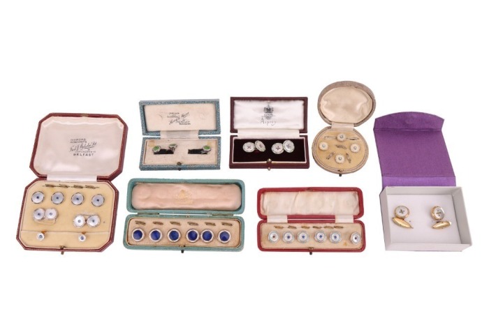 A matched gold, mother-of-pearl and sapphire dress set, in fitted case; together with a pair of silver, mother-of-pearl and enamel cufflinks, adapted from buttons, with later links; two sets of six gilt metal and enamel buttons in fitted cases, circa 1910