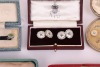 A matched gold, mother-of-pearl and sapphire dress set, in fitted case; together with a pair of silver, mother-of-pearl and enamel cufflinks, adapted from buttons, with later links; two sets of six gilt metal and enamel buttons in fitted cases, circa 1910 - 5