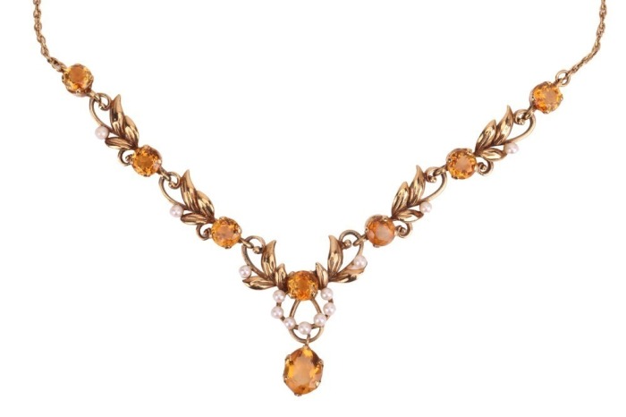 A gem-set floral necklace, composed of round-cut citrines and cultured pearls, set between foliate and scrolling links, to a single suspended oval-cut citrine, with a twist yellow metal chain and bolt ring clasp marked &lsquo;9ct&rsquo;; 16.0 grams.