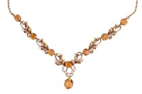 A gem-set floral necklace, composed of round-cut citrines and cultured pearls, set between foliate and scrolling links, to a single suspended oval-cut citrine, with a twist yellow metal chain and bolt ring clasp marked &lsquo;9ct&rsquo;; 16.0 grams.