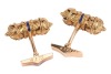 A pair of Etruscan-style cufflinks, of hollow scroll holder form, with twisted cable and granulated details, accentuated with a line of navy enamel at the centre, toggle fittings with personal inscription, in yellow metal stamped 'K18', 2.8 cm wide, 18.5 - 3