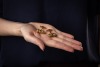 A pair of Etruscan-style cufflinks, of hollow scroll holder form, with twisted cable and granulated details, accentuated with a line of navy enamel at the centre, toggle fittings with personal inscription, in yellow metal stamped 'K18', 2.8 cm wide, 18.5 - 5
