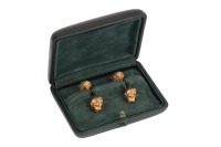 Lalaounis - a pair of lion head cufflinks, of dumbbell form, the bar terminated with a sculpted lion head on both ends, in yellow metal stamped '750', with Lalaounis maker's mark, 3.5 cm, 18.4 grams.