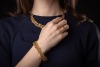 An emerald and diamond parure; comprising a necklace, a bracelet, a pair of earrings and a cocktail ring; of textured and braided design, embellished with lines of graduated circular-cut emeralds, and round brilliant-cut diamond clusters; the collar neckl - 12