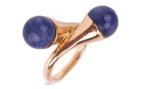 Gucci- a lapis lazuli cross-over ring in 9ct yellow gold, featuring two spherical lapis lazuli bead finials of 8.0 mm, mounted to the tapered bypass shoulders, leading to a D-profile shank, London 1976, sponsor's mark 'FJLd', size E, in original Gucci rin