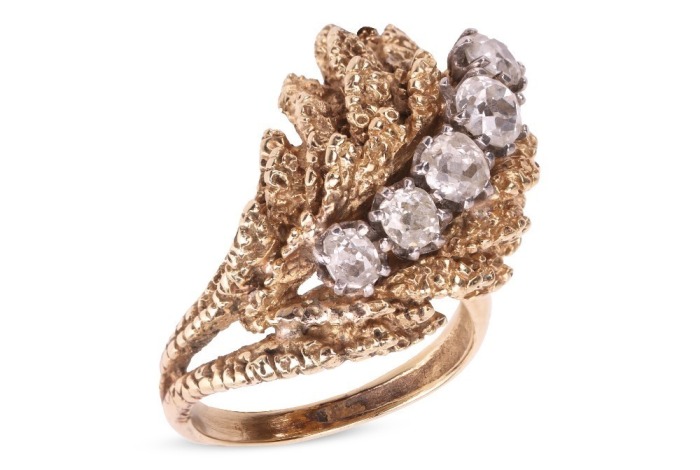 A Modernist diamond-set cocktail ring in the form of a textured foliate, the stylised and layered foliate mount claw-set with five old-cut diamonds, with an estimated total weight of 1.18ct, in unmarked yellow metal surface testing as 14ct, ring head 2.7 